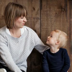 Child smiling at woman making a funny face