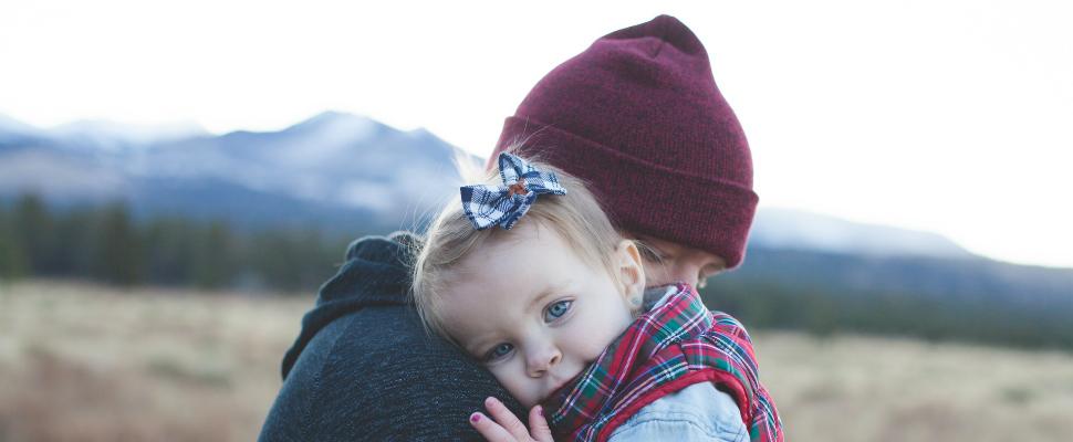 Man holding young girl close