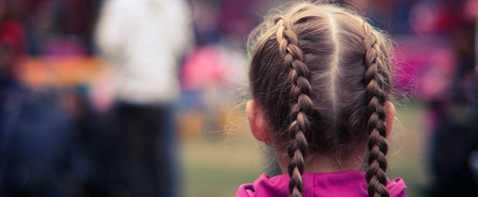 Girl in pink jumper with pigtails