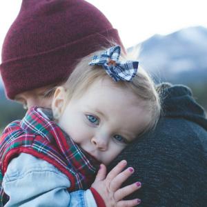 Man holding baby close like a cuddle