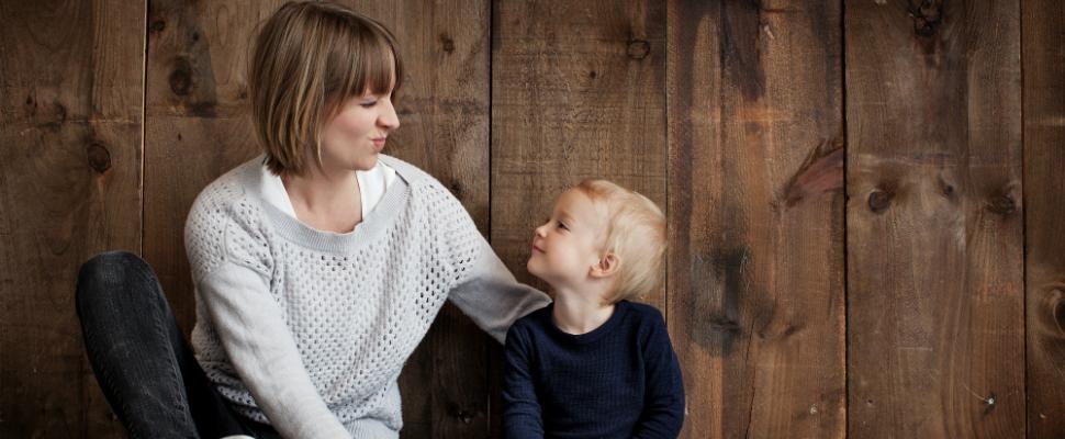 Woman making funny face at amused child