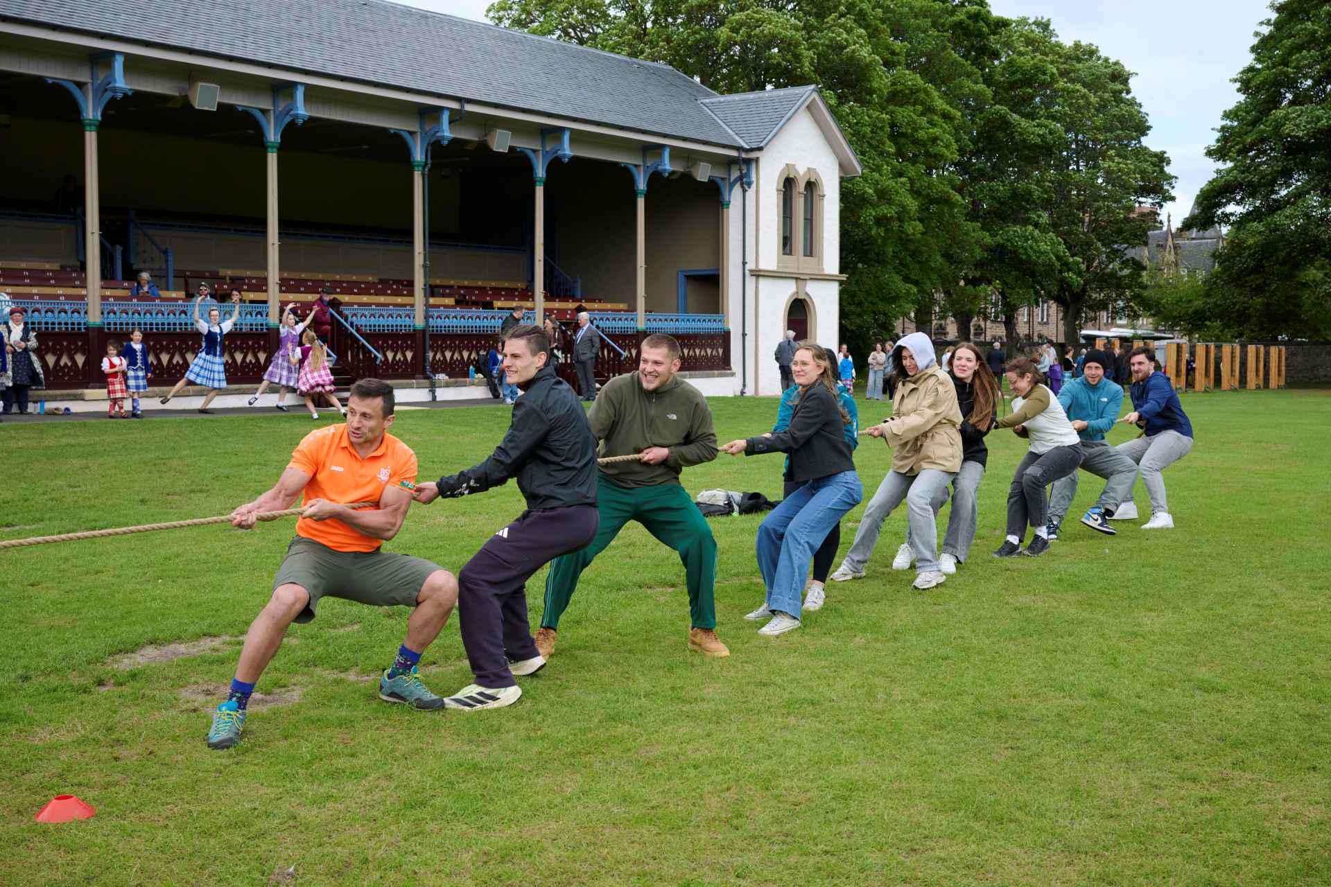 Ten young people pulling tug of war rope at Northern Meeting Park