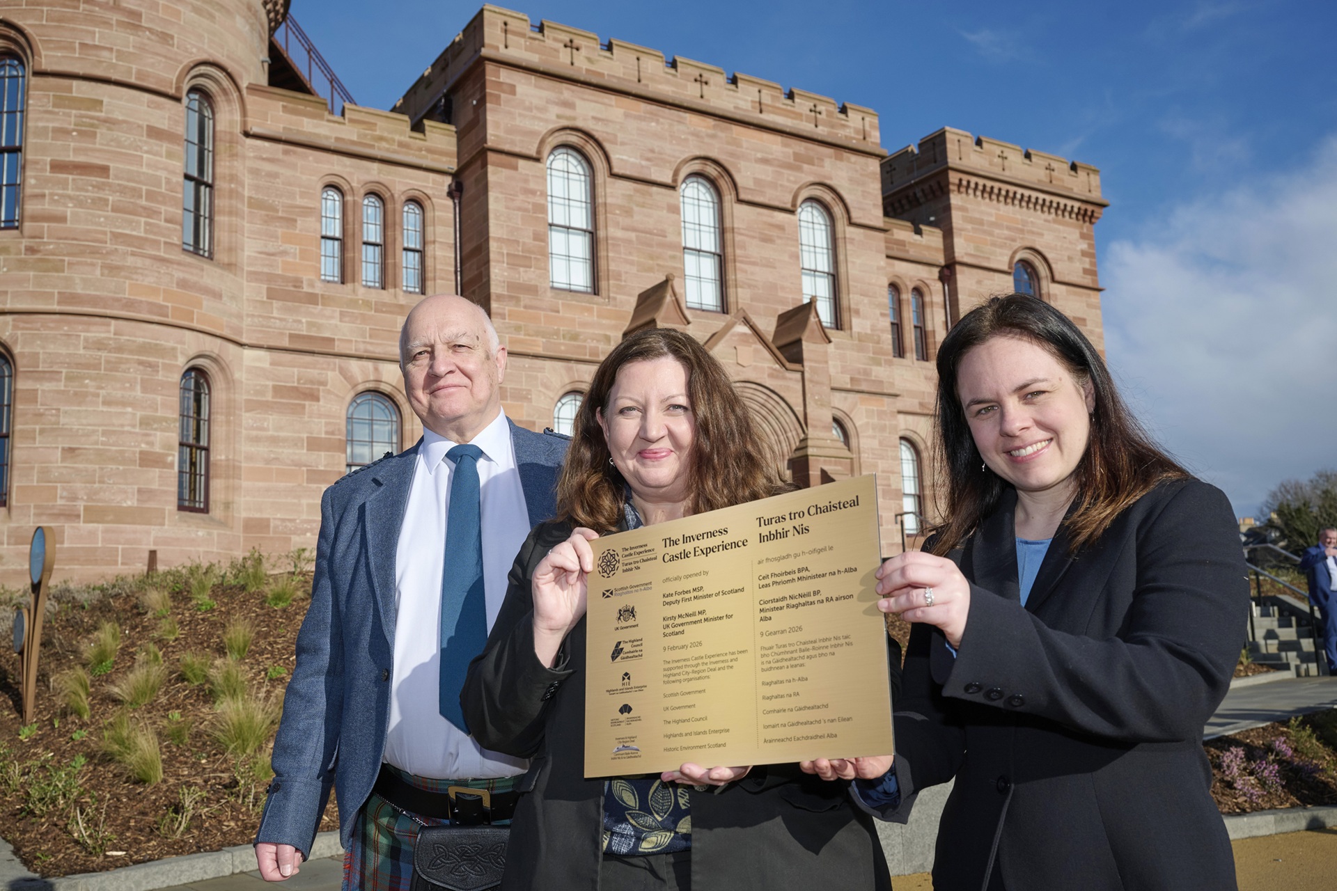The Convener of Highland Council along with Kate Forbes, Deputy First Minister of Scotland, and Kirsty McNeill, UK Government Minister for Scotland, with a plaque, outside Inverness Castle.