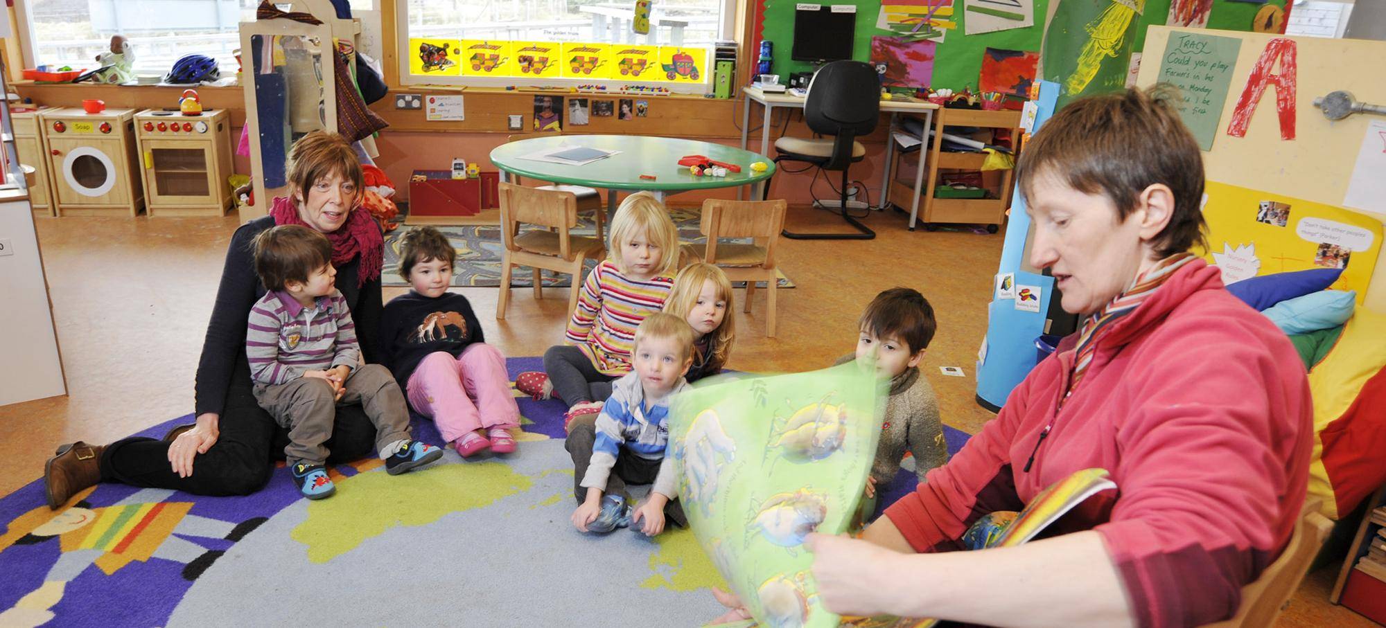 Nursery children being read a story