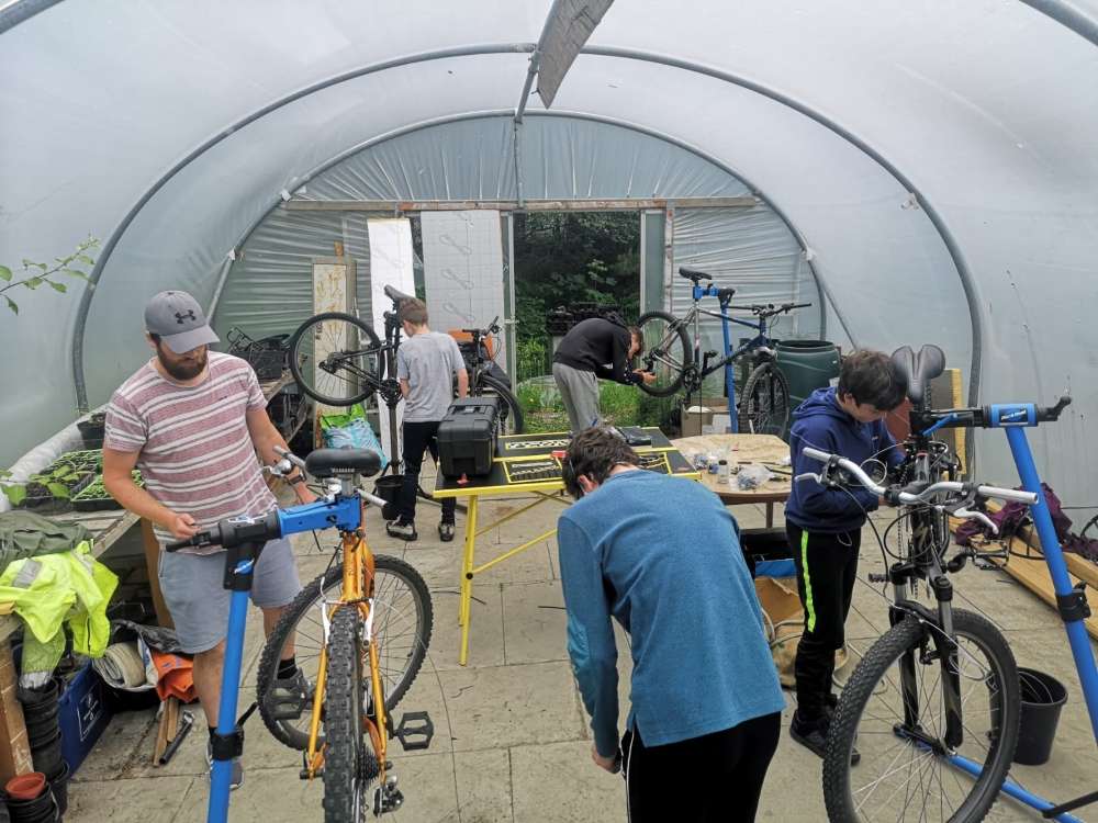 Photo of a bike repair workshop underway