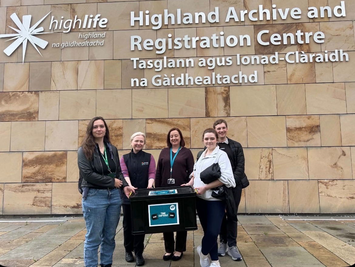 With their time capsule are young people from HYP and Highland Youth Convener Eilidh Primrose, Leah McBain (previous HYC) and Hamish Nott with Alison Mason, Highland Archivist and Jennifer Johnstone, Archivist, High Life Highland Highland Archive Centre.