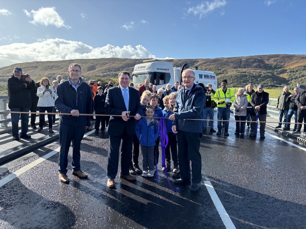 Cutting the ribbon – Cllr Ken Gowans, flanked by Jonathan Wills (left) and Jim Johnston (right) along with local school pupils